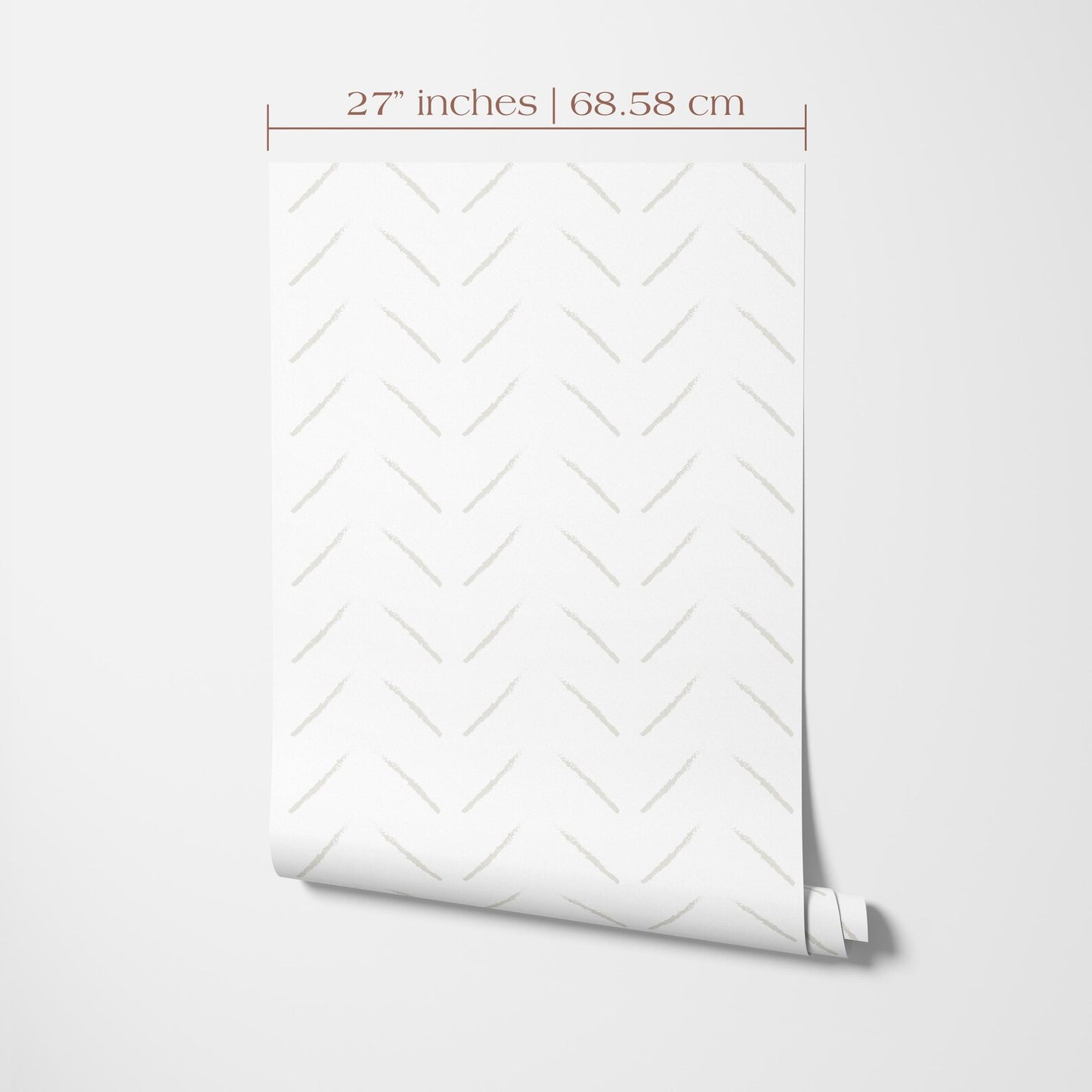 a white wall with a rolled-up patterned wallpaper or paper displayed on it.
