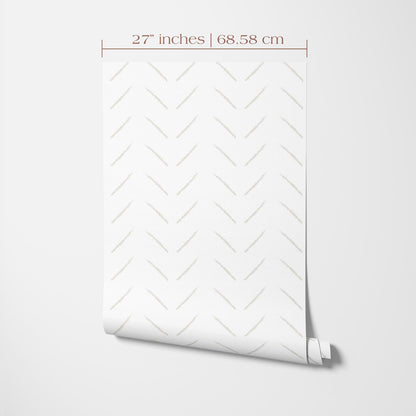 a white wall with a rolled-up patterned wallpaper or paper displayed on it.