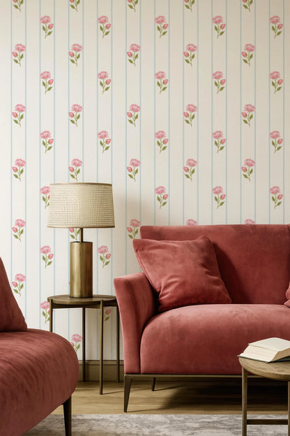 a cozy living room with a red sofa, a wooden coffee table, and a lamp on a side table. The walls are adorned with a floral wallpaper pattern, and the room has a warm and inviting atmosphere.