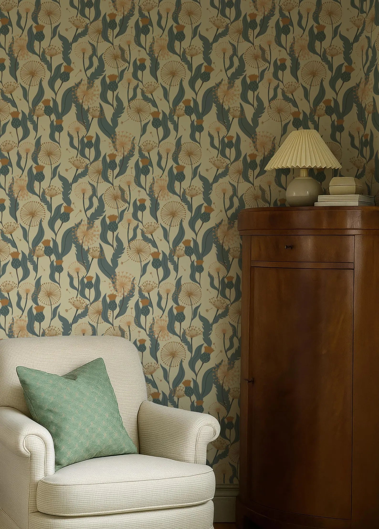 a cozy living room with a white armchair, a wooden cabinet, and a patterned wallpaper with a floral design.