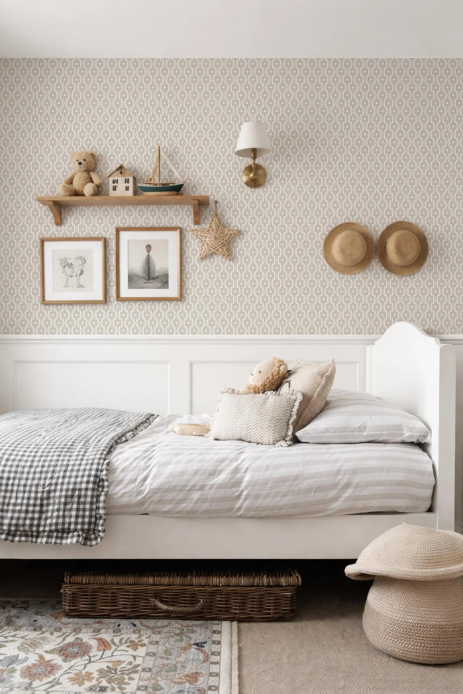 a cozy and well-decorated bedroom with a white bed, a shelf with toys, and a patterned wallpaper.