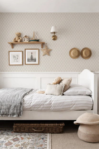 a cozy and well-decorated bedroom with a white bed, a shelf with toys, and a patterned wallpaper.