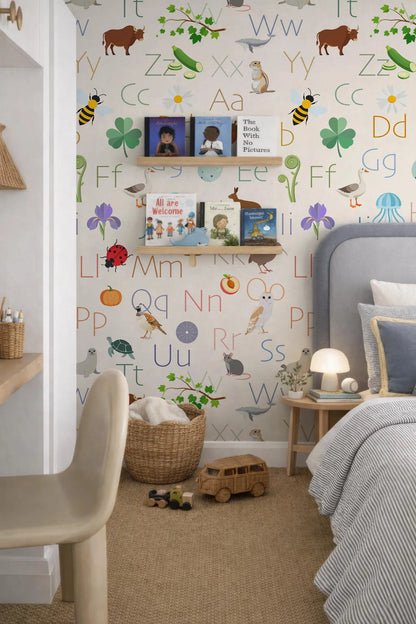 a child's bedroom with a colorful alphabet wall, a bookshelf, and a bed. The wall is decorated with various animal illustrations and letters, creating a vibrant and playful atmosphere.