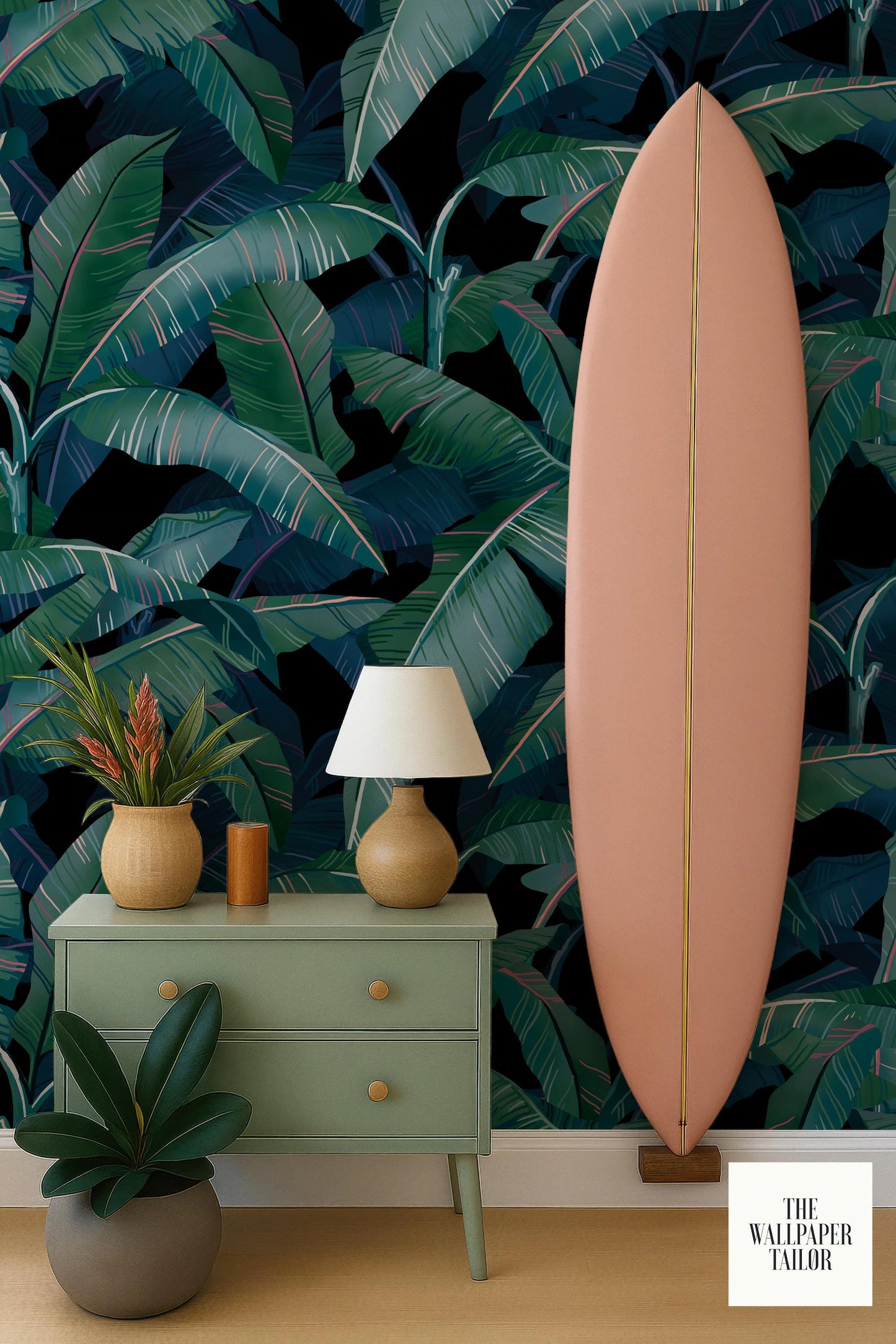 a vibrant and tropical-themed room with a large, pink surfboard leaning against a wall adorned with a bold, tropical wallpaper pattern. The room is decorated with a green dresser, a lamp, and a potted plant, creating a cozy and inviting atmosphere.