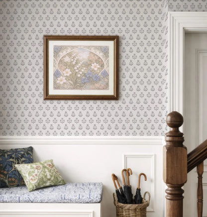 a cozy and well-decorated room with a framed floral artwork hanging on the wall, a wooden staircase, a bench with pillows, and a basket of umbrellas.