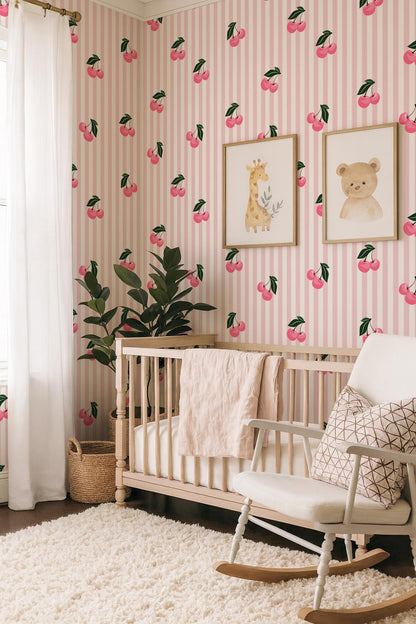a nursery room with a pink and white striped wallpaper, a wooden crib, a white rocking chair, and two framed animal illustrations on the wall.