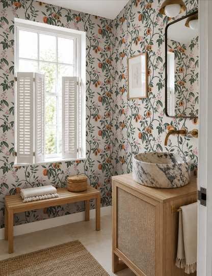 a bathroom with a marble sink, a wooden vanity, and a window with white shutters. The walls are covered in a floral wallpaper, and there is a woven basket on the vanity.