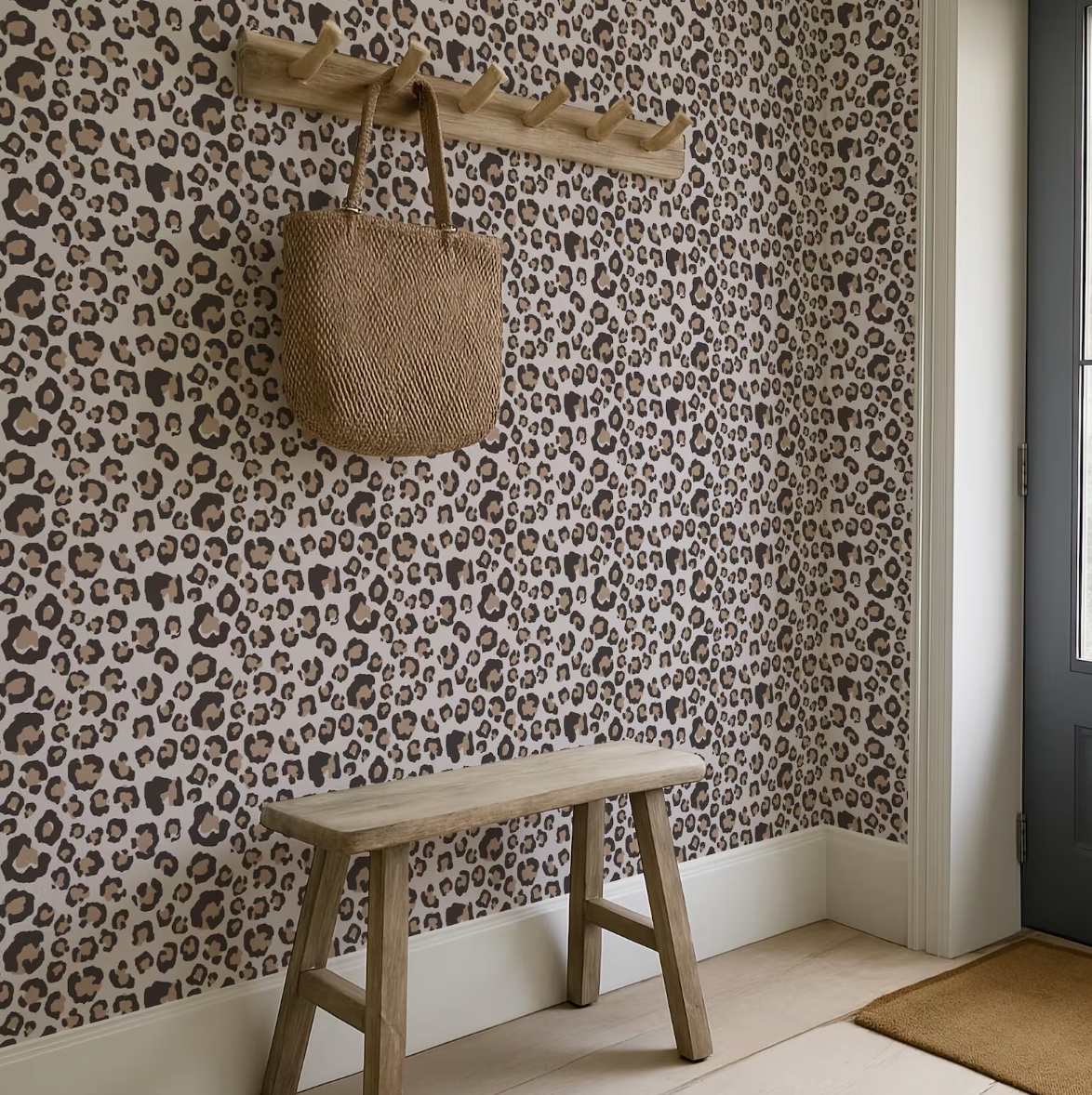 a leopard print wallpaper in a room with a wooden bench and a wooden coat rack.