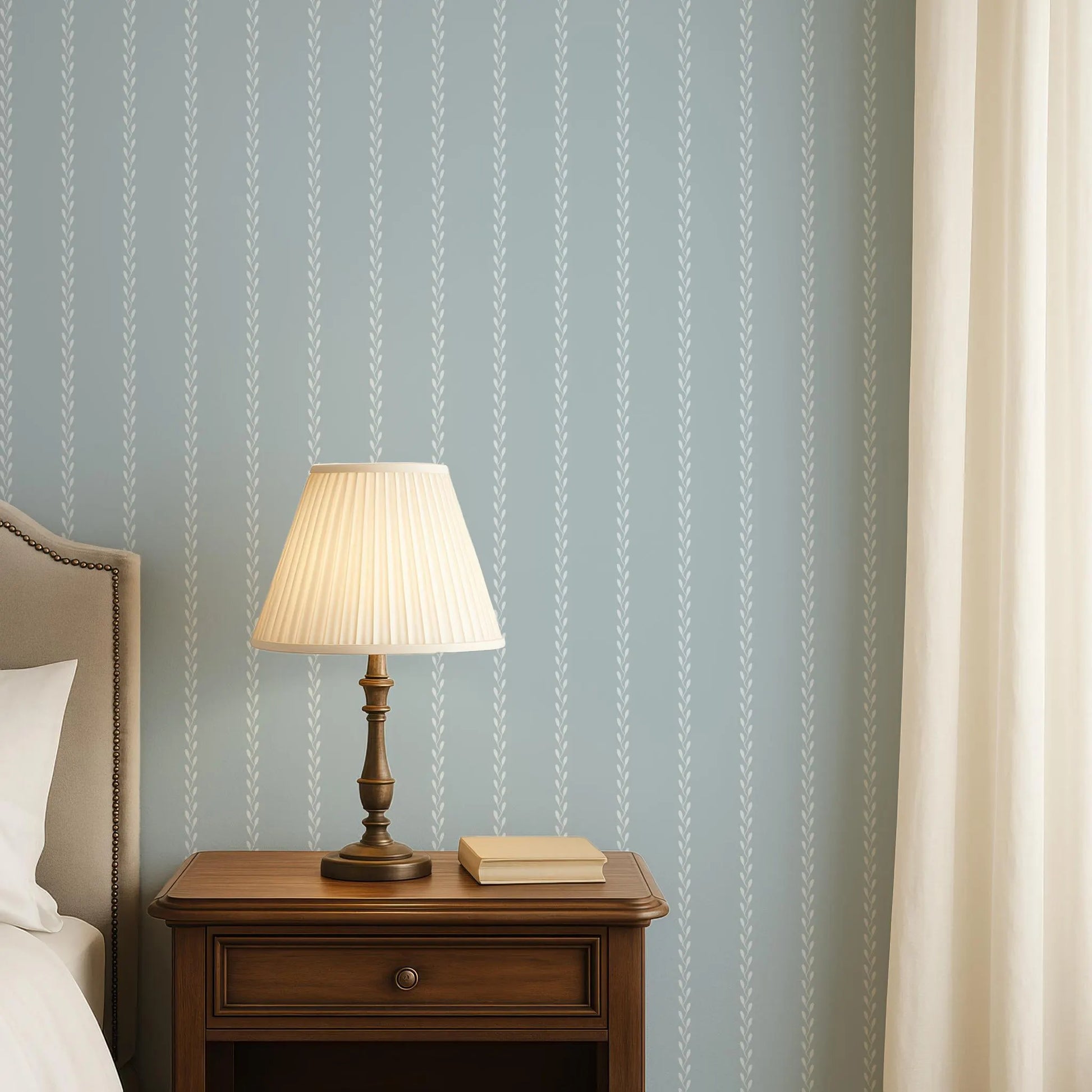 a bedroom scene with a wooden nightstand, a lamp, and a book on the nightstand.
