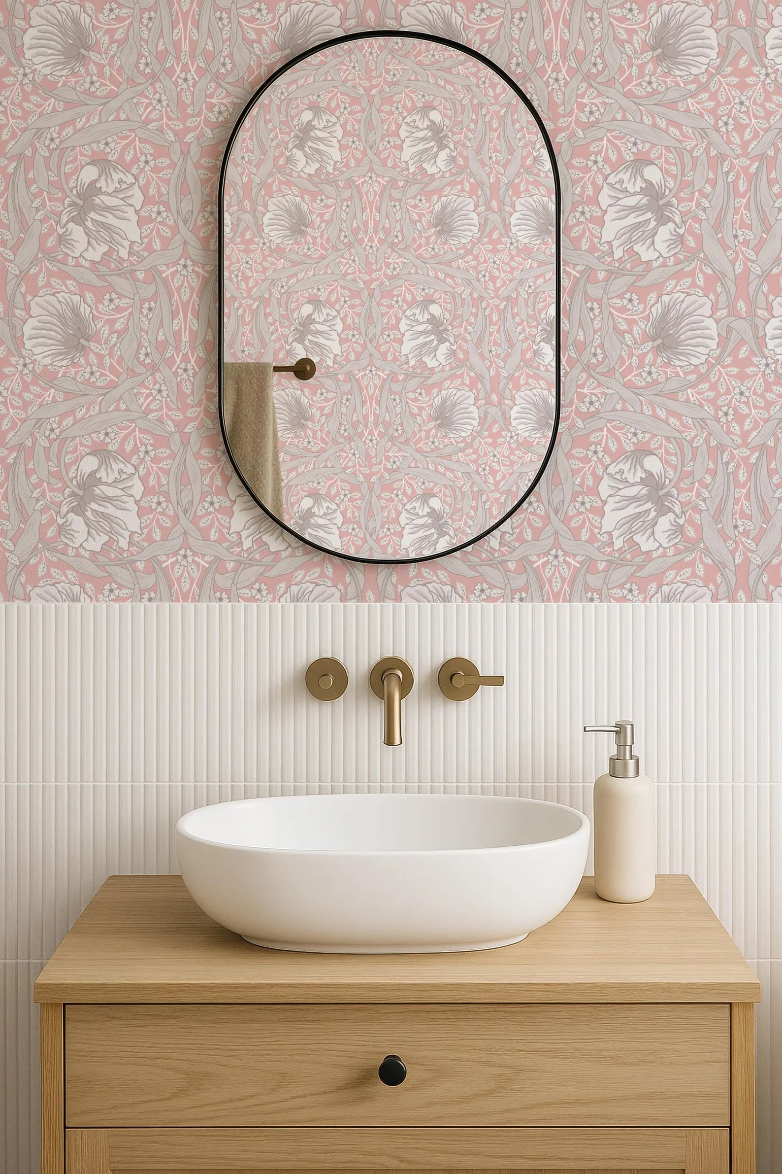 a bathroom with a white sink, a mirror, and a wooden vanity. The walls are decorated with a pink and white floral pattern, and the overall color scheme is neutral.