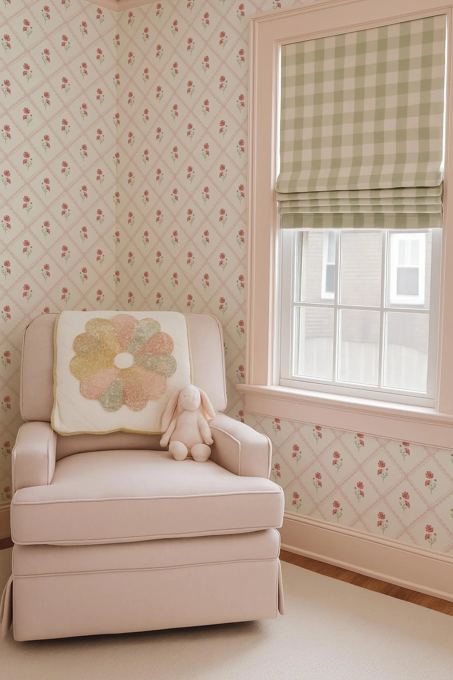 a cozy nursery scene with a plush white chair, a stuffed bunny, and a window with a green and white checkered curtain.