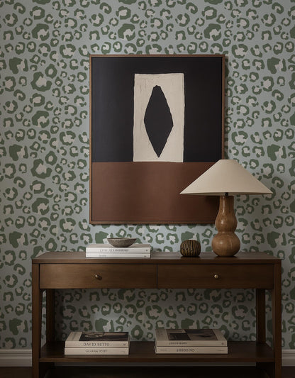 a wooden console table with a lamp, books, and a framed abstract artwork on the wall above it.