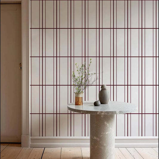 a minimalist interior design with a white table and a vase of greenery on it, set against a white wall with a grid pattern.