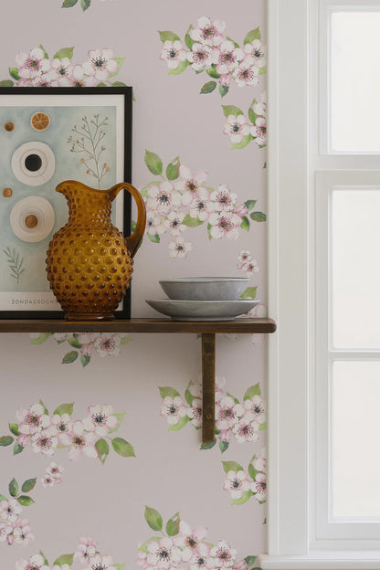 a shelf with a brown vase, a bowl, and a picture frame, set against a wall with a floral wallpaper.