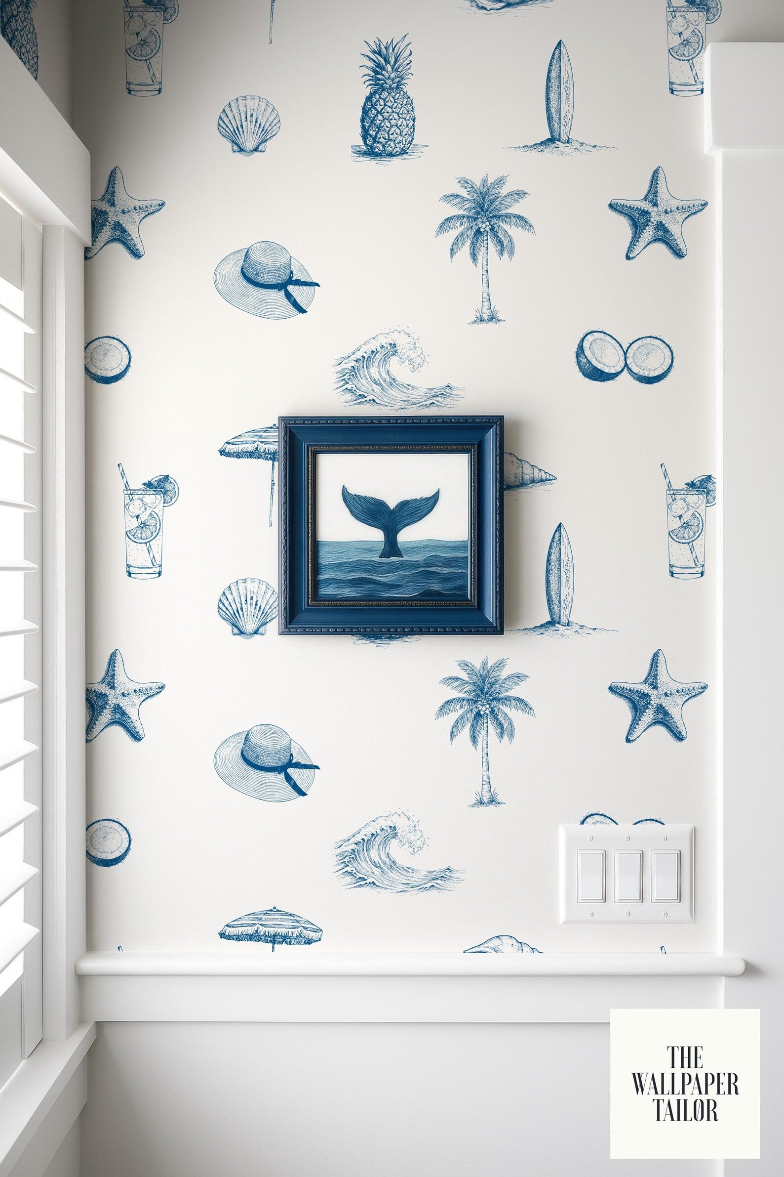 a wallpapered wall with a framed picture of a whale, a surfboard, a palm tree, and other nautical and beach-themed illustrations.