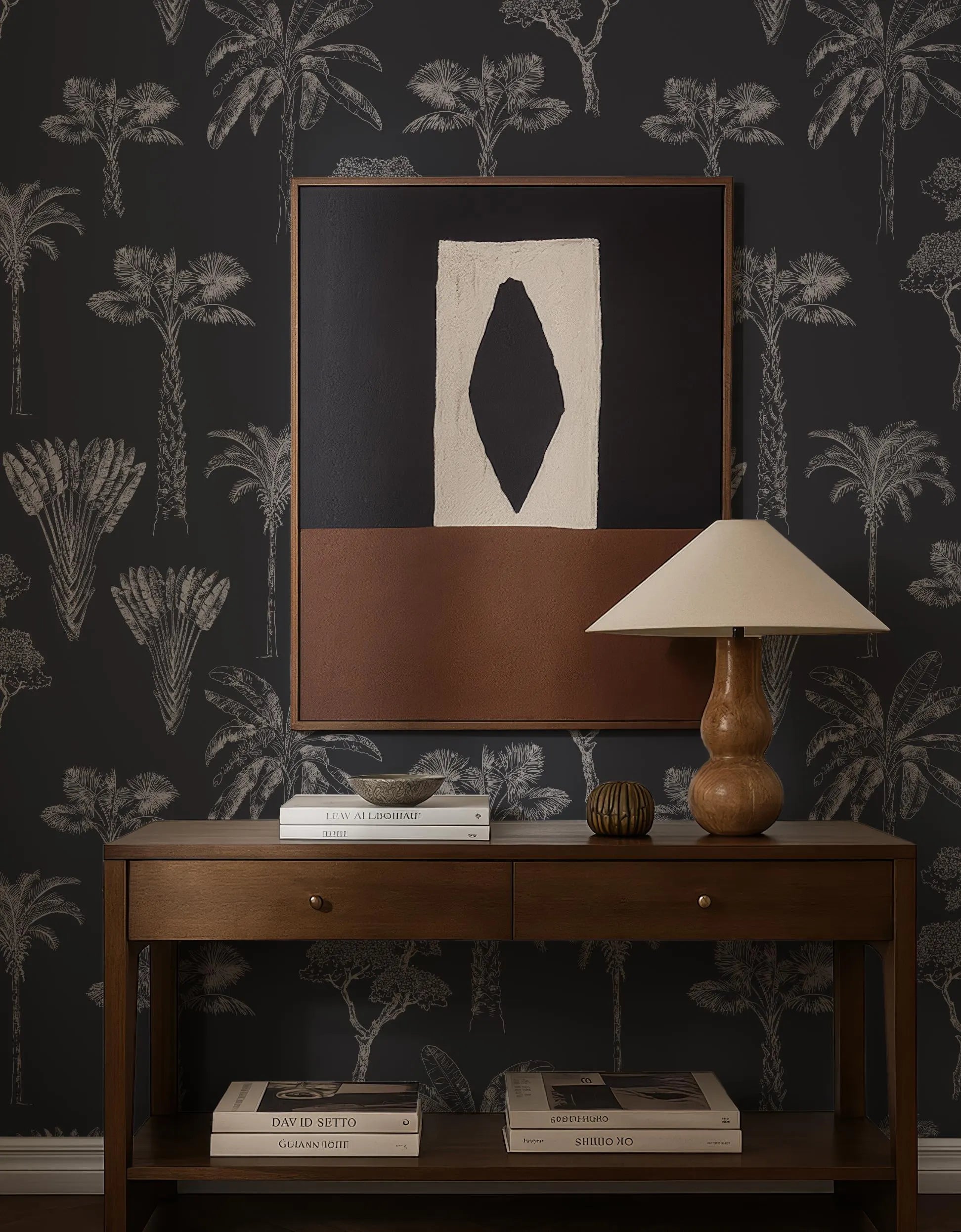 a wooden console table with a lamp, books, and a framed abstract artwork on the wall above it.