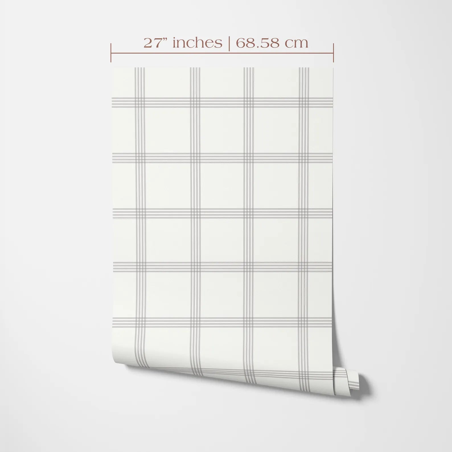 a white wall with a roll of wallpaper or a similar material displayed on it. The wallpaper has a grid pattern with vertical and horizontal lines, creating a checkered or striped appearance. The image is described as having a size of 27 inches by 68.58 centimeters.