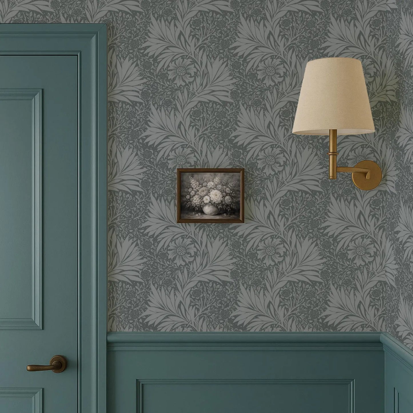a room with a teal door, a wallpapered wall with a floral pattern, a framed picture hanging on the wall, and a wall-mounted lamp.