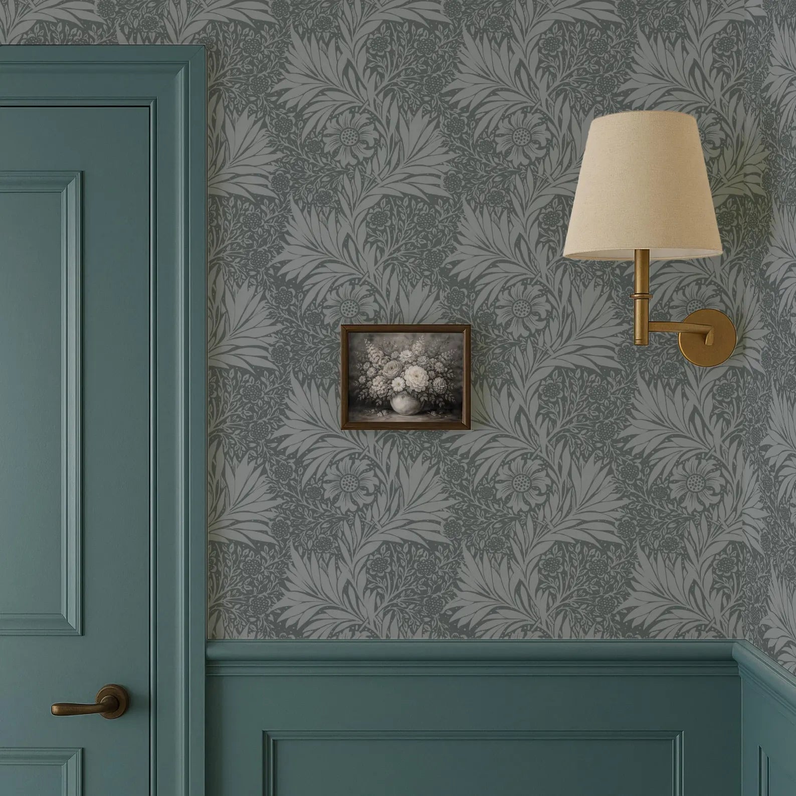 a room with a teal door, a wallpapered wall with a floral pattern, a framed picture hanging on the wall, and a wall-mounted lamp.