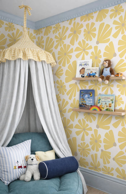 a cozy and colorful children's bedroom with a canopy bed, yellow and white floral wallpaper, and shelves displaying children's books and toys.