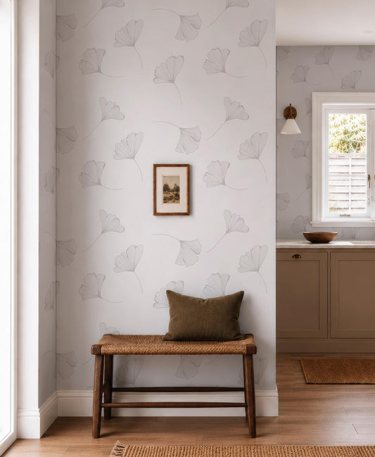 a cozy corner of a room with a wooden bench, a framed picture on the wall, and a window with a view of the outdoors.