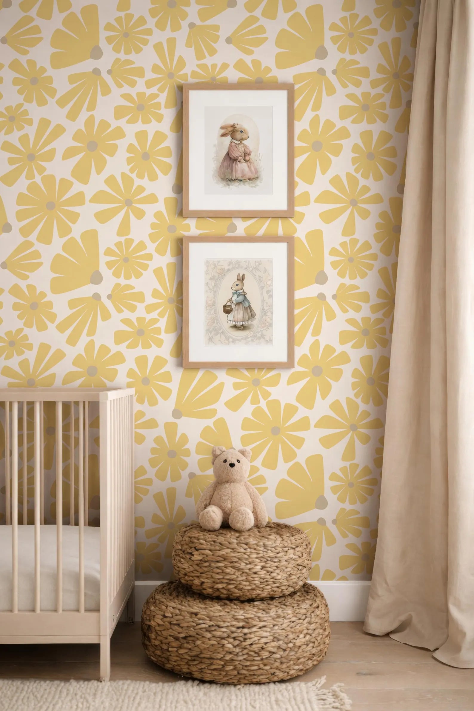 a nursery room with a yellow and white floral wallpaper, a wooden crib, and two framed pictures of rabbits on the wall. A small stuffed teddy bear is sitting on a woven basket in the foreground.