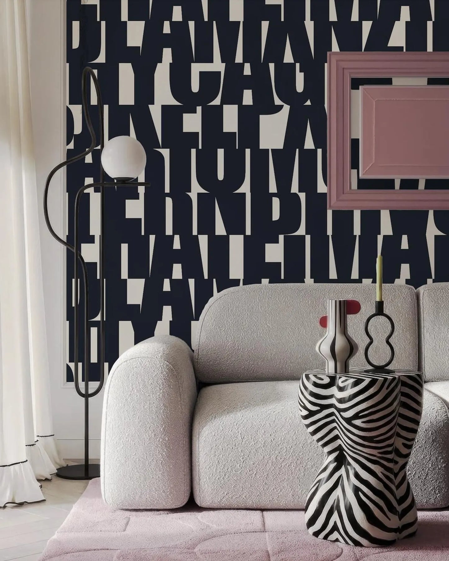 a modern living room with a white sofa, a zebra-patterned side table, and a black floor lamp. The wall behind the sofa has a large black and white text design, creating a bold and striking visual element in the space.
