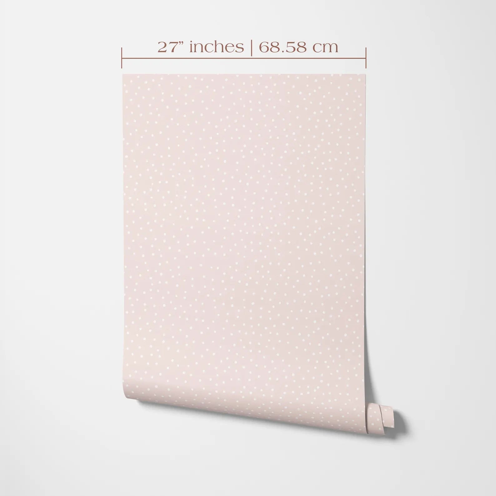 a piece of paper or fabric with a pattern of small dots or dots on it, which appears to be a light pink color. The paper is rolled up and placed against a white background.