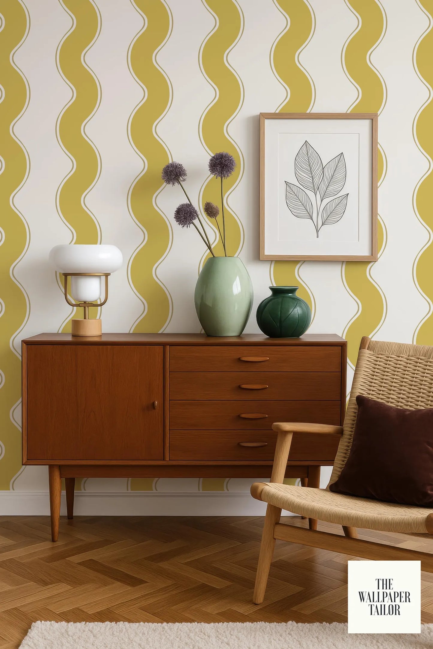 a vintage-style living room with a wooden cabinet, a woven chair, and a framed artwork on the wall. The wall has a yellow and white striped pattern, and there are two vases on the cabinet, one with purple flowers and the other with green flowers.