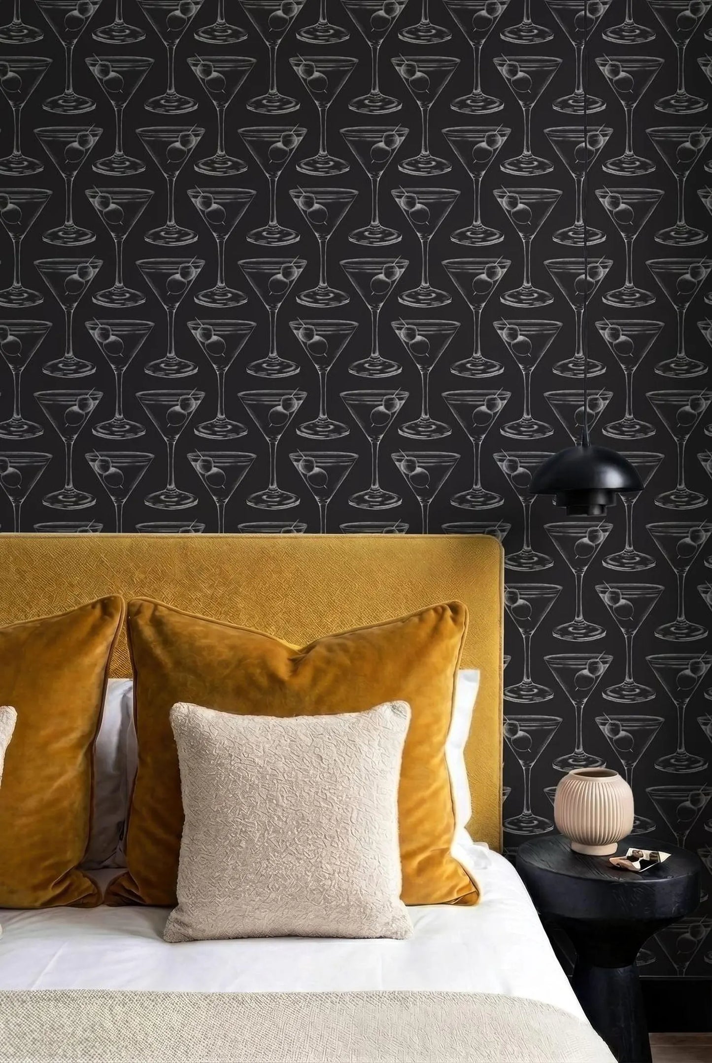 a bedroom with a black and white patterned wallpaper, a yellow headboard, and a bed with yellow and beige pillows.