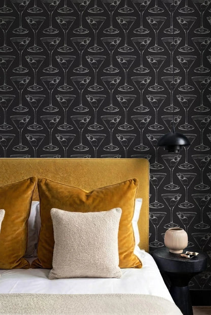 a bedroom with a black and white patterned wallpaper, a yellow headboard, and a bed with yellow and beige pillows.