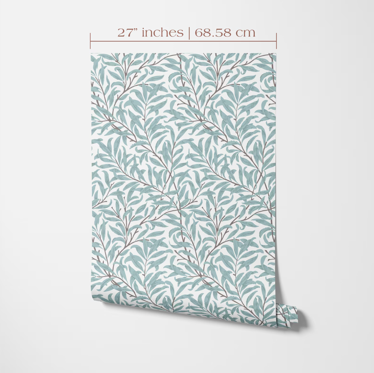 a patterned wallpaper or wall covering with a repeating design of green leaves and branches. The pattern is displayed on a white background, and there is a measurement scale indicating the size of the pattern in inches and centimeters.