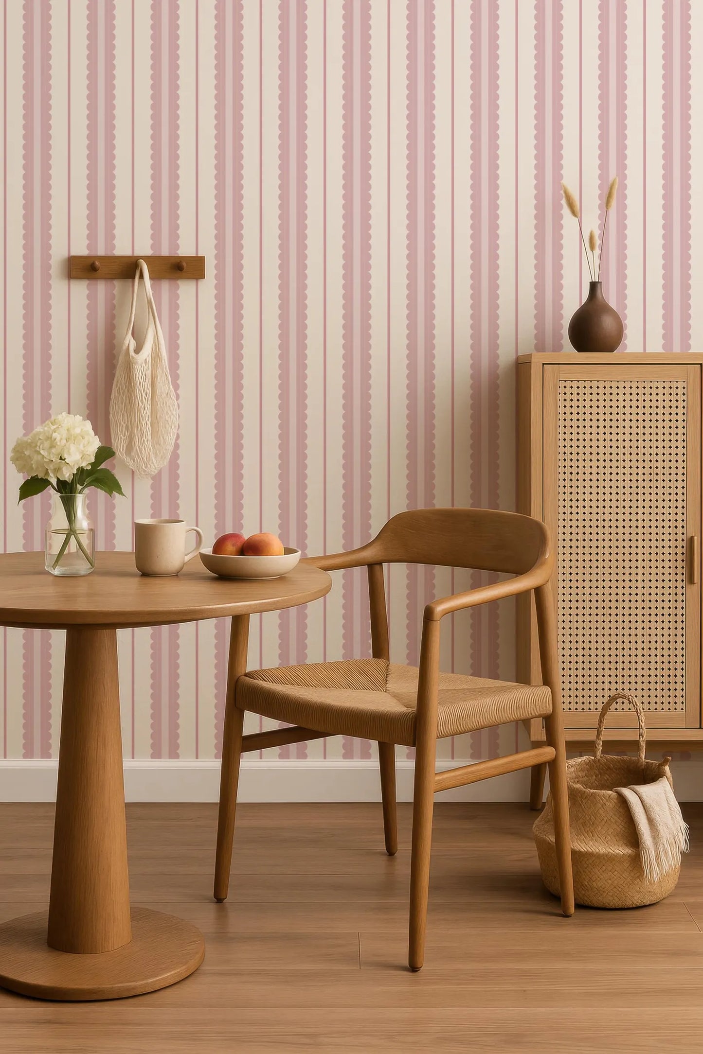 a cozy and inviting living space with a wooden chair, a round wooden table, and a woven basket. The walls are adorned with pink and white striped wallpaper, and the room has a warm and rustic ambiance.