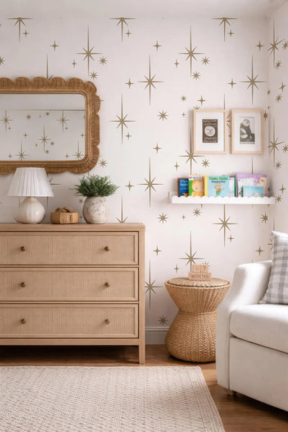 a cozy and well-decorated nursery room with a white color scheme, featuring a wooden dresser, a mirror, a bookshelf, and a wicker side table.