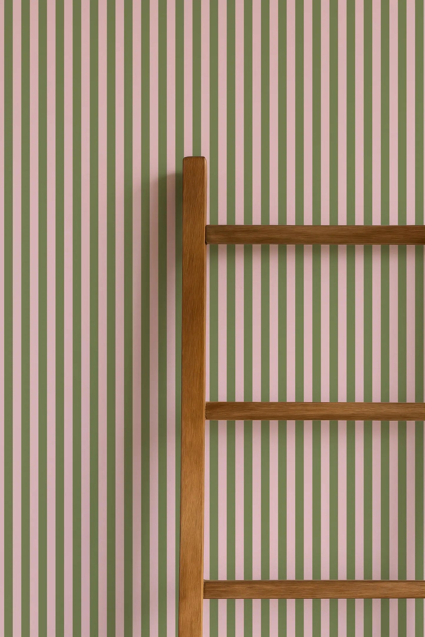 a wooden ladder leaning against a striped wall.