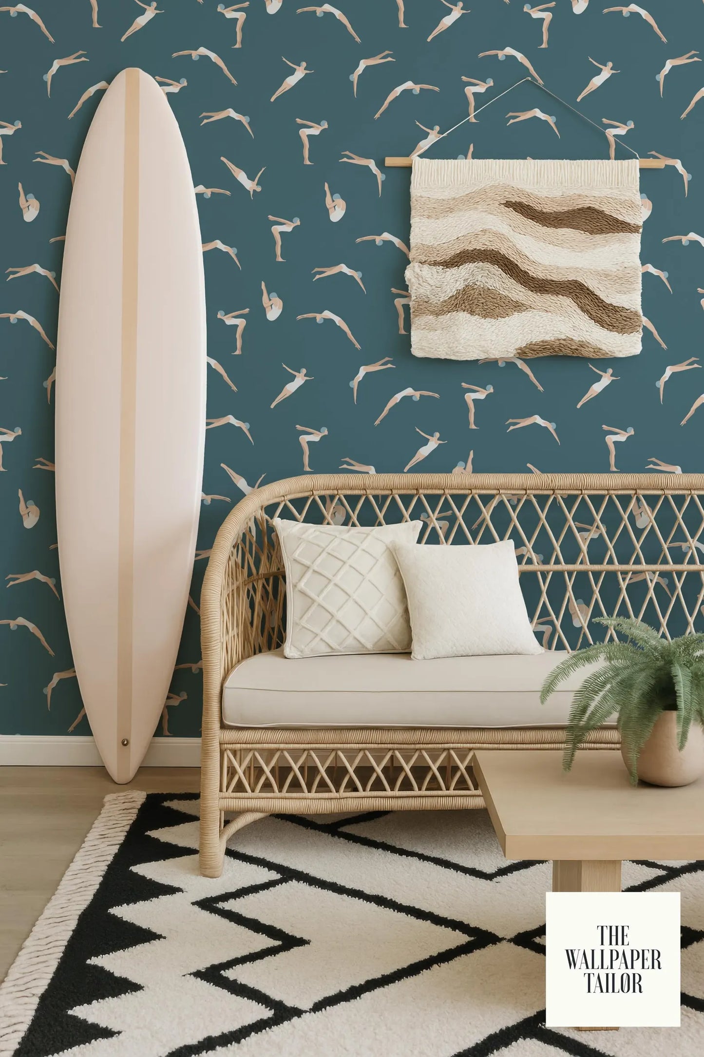 a living room with a wicker bench, a surfboard, and a woven wall hanging. The wall has a pattern of seagulls and waves, creating a beach-inspired atmosphere. The room also includes a rug and a potted plant, adding to the cozy and inviting ambiance.