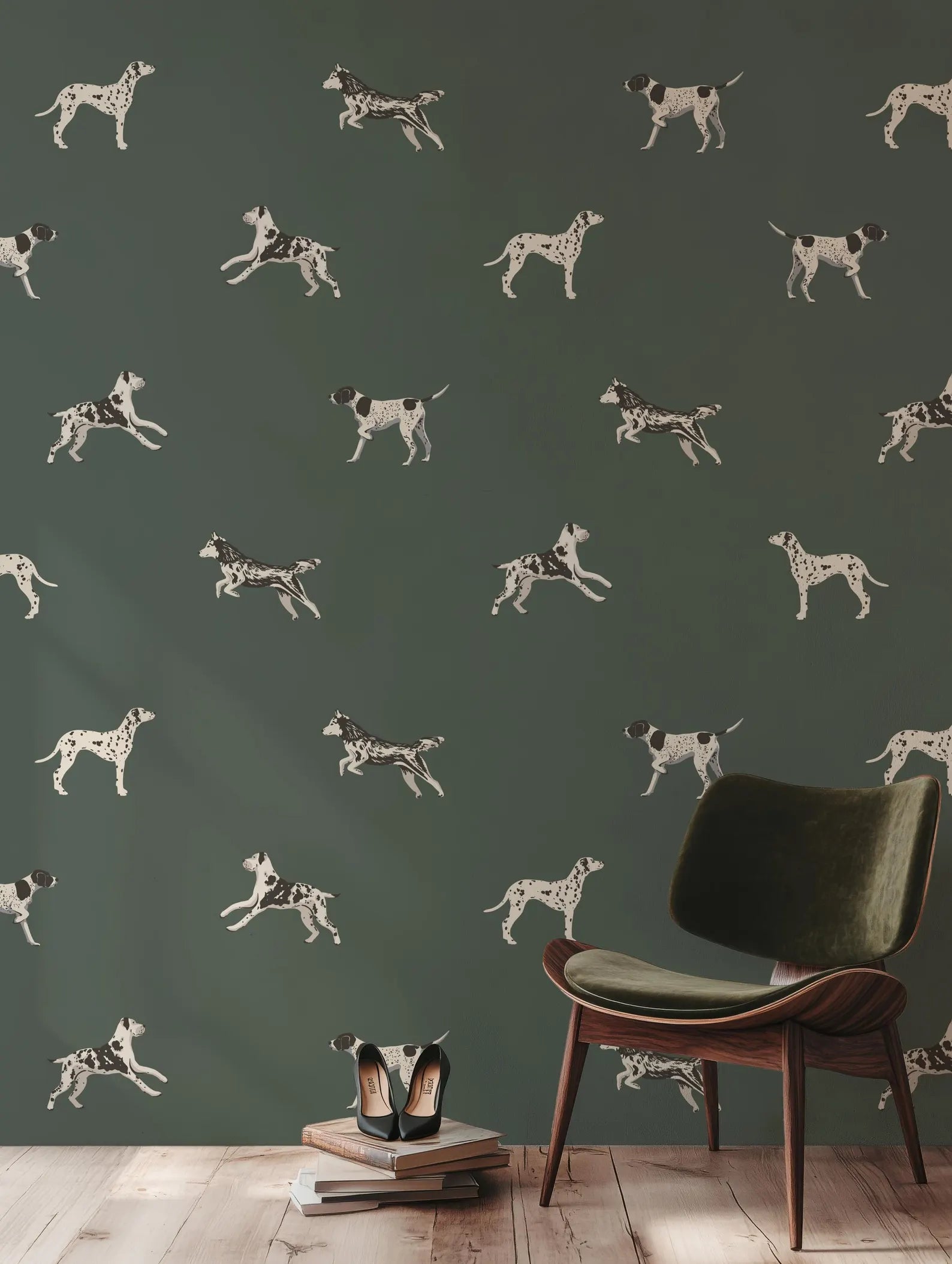 a wallpapered wall with a repeating pattern of black and white dog silhouettes, creating a visually striking and dynamic design. In the foreground, there is a green armchair and a stack of books, suggesting a cozy and intellectual atmosphere.