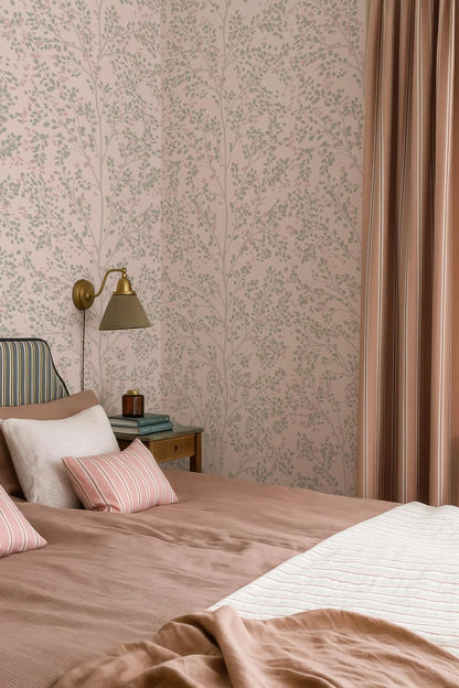 a cozy bedroom with a large bed, a nightstand, and a lamp. The walls are covered in a floral wallpaper, and the room has a warm, inviting atmosphere.