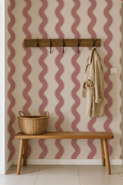 a wooden bench with a wicker basket on it, set against a wall with a wavy pattern in shades of pink and white.