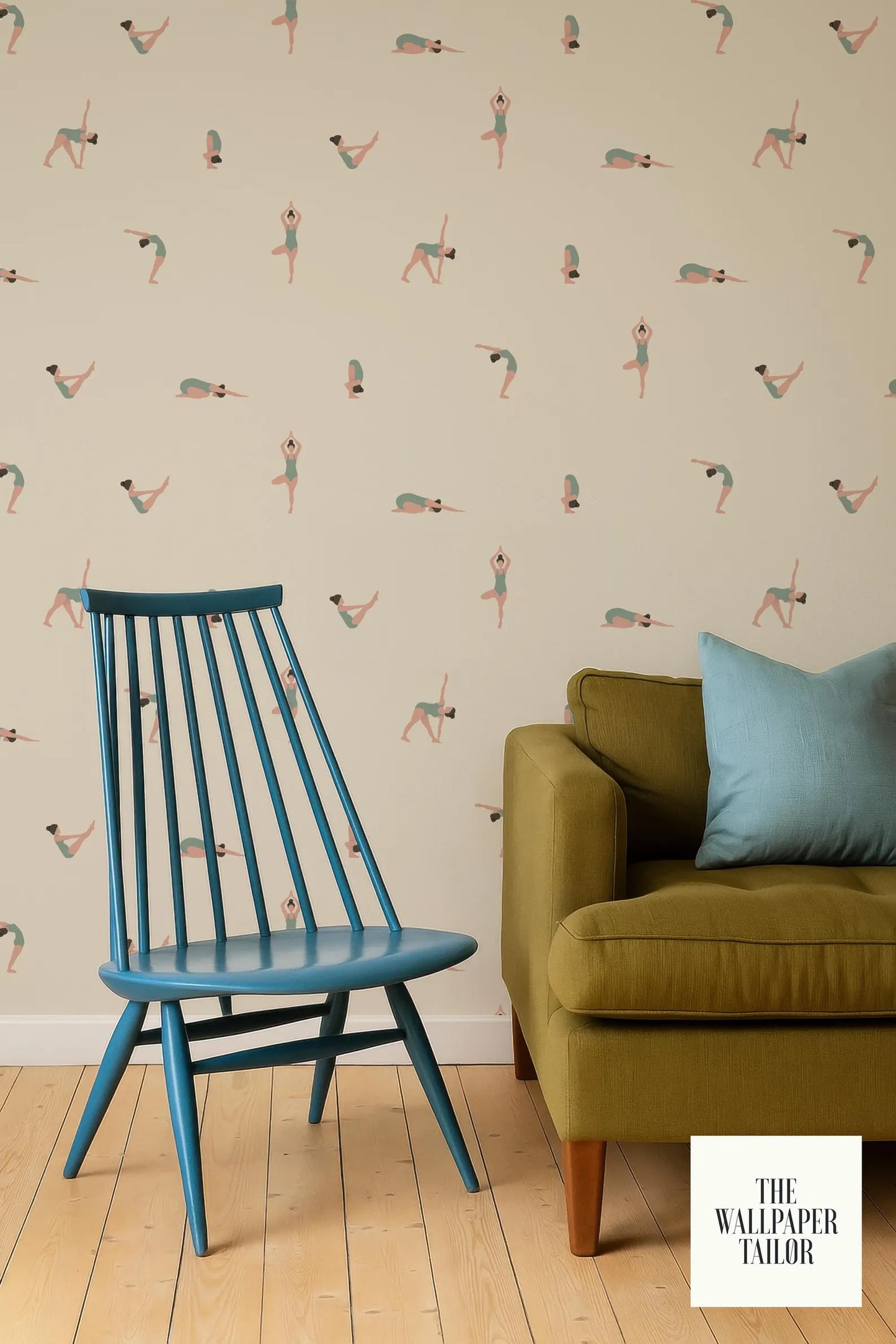 a blue chair and a green sofa against a wall with a repeating pattern of dancing figures.
