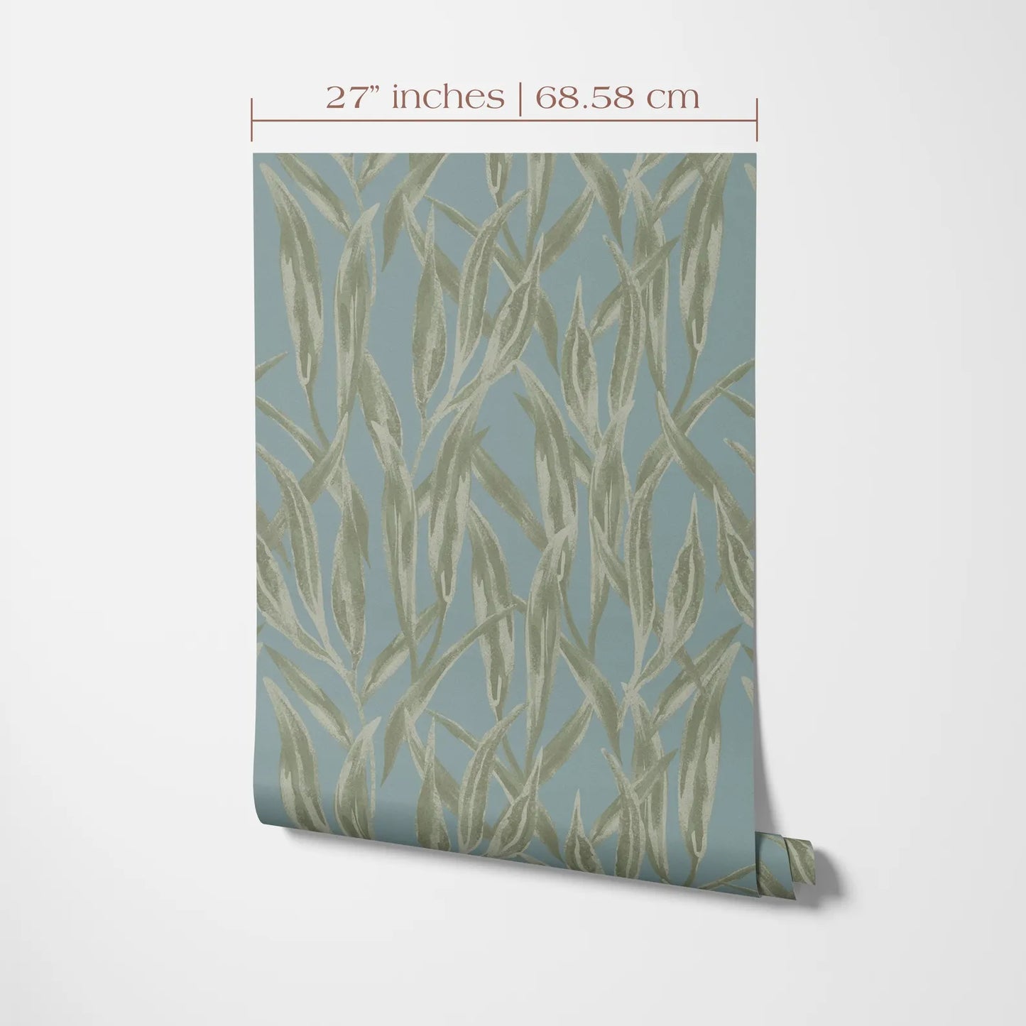 a piece of wall art with a repeating pattern of green leaves or plant-like shapes on a light blue background.