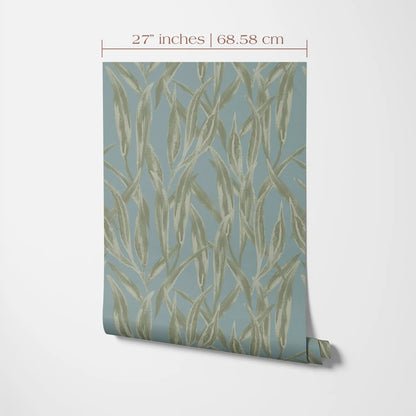 a piece of wall art with a repeating pattern of green leaves or plant-like shapes on a light blue background.