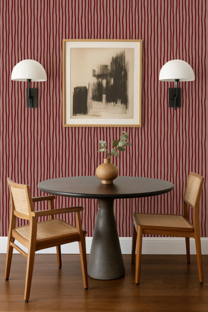 a modern dining area with a round table, two wooden chairs, and a framed abstract artwork on the wall above the table.