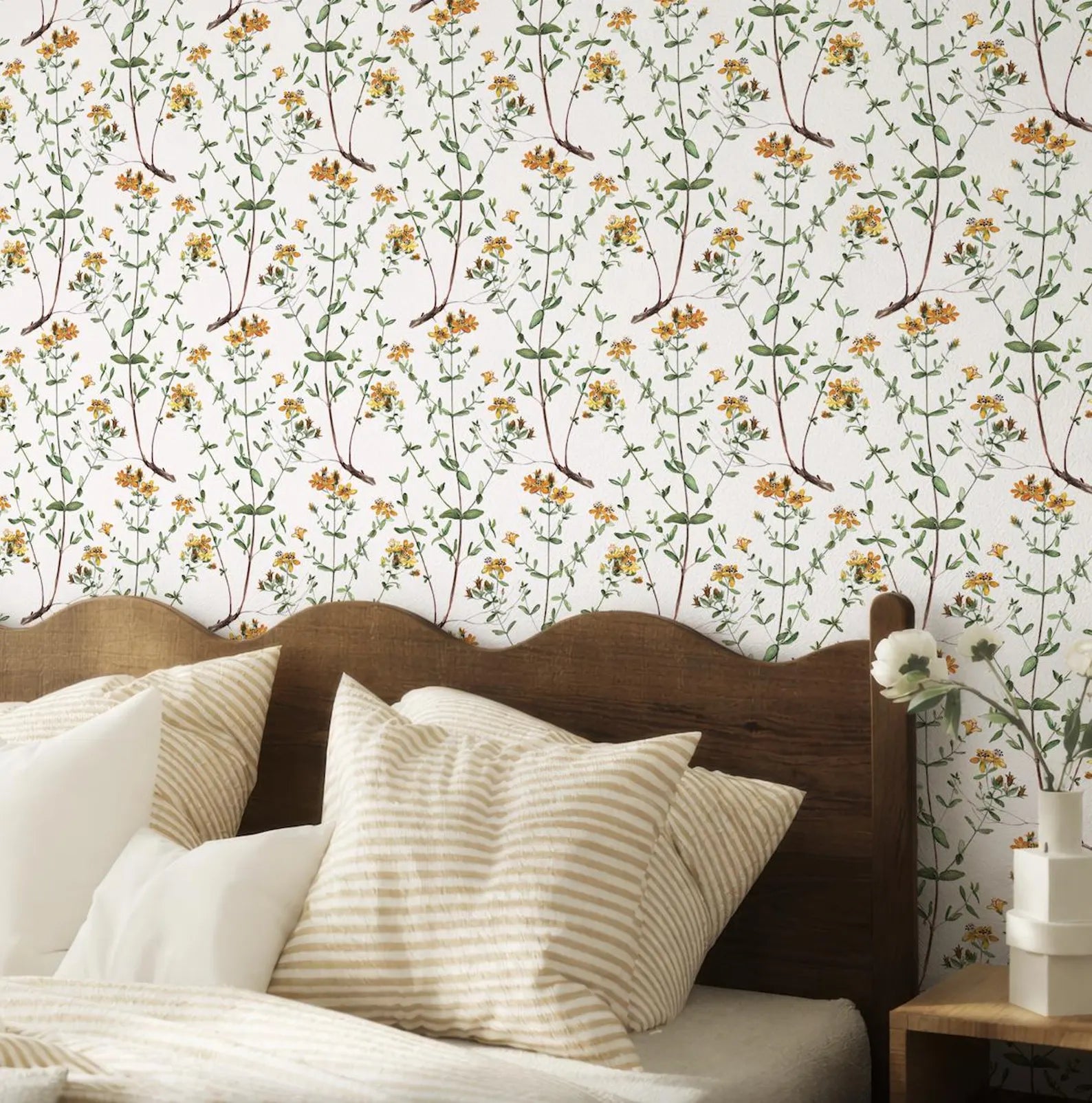 a bedroom with a wooden headboard and a floral wallpaper behind it. The room has a cozy and inviting atmosphere, with a bed adorned with striped pillows and a wooden nightstand next to it.