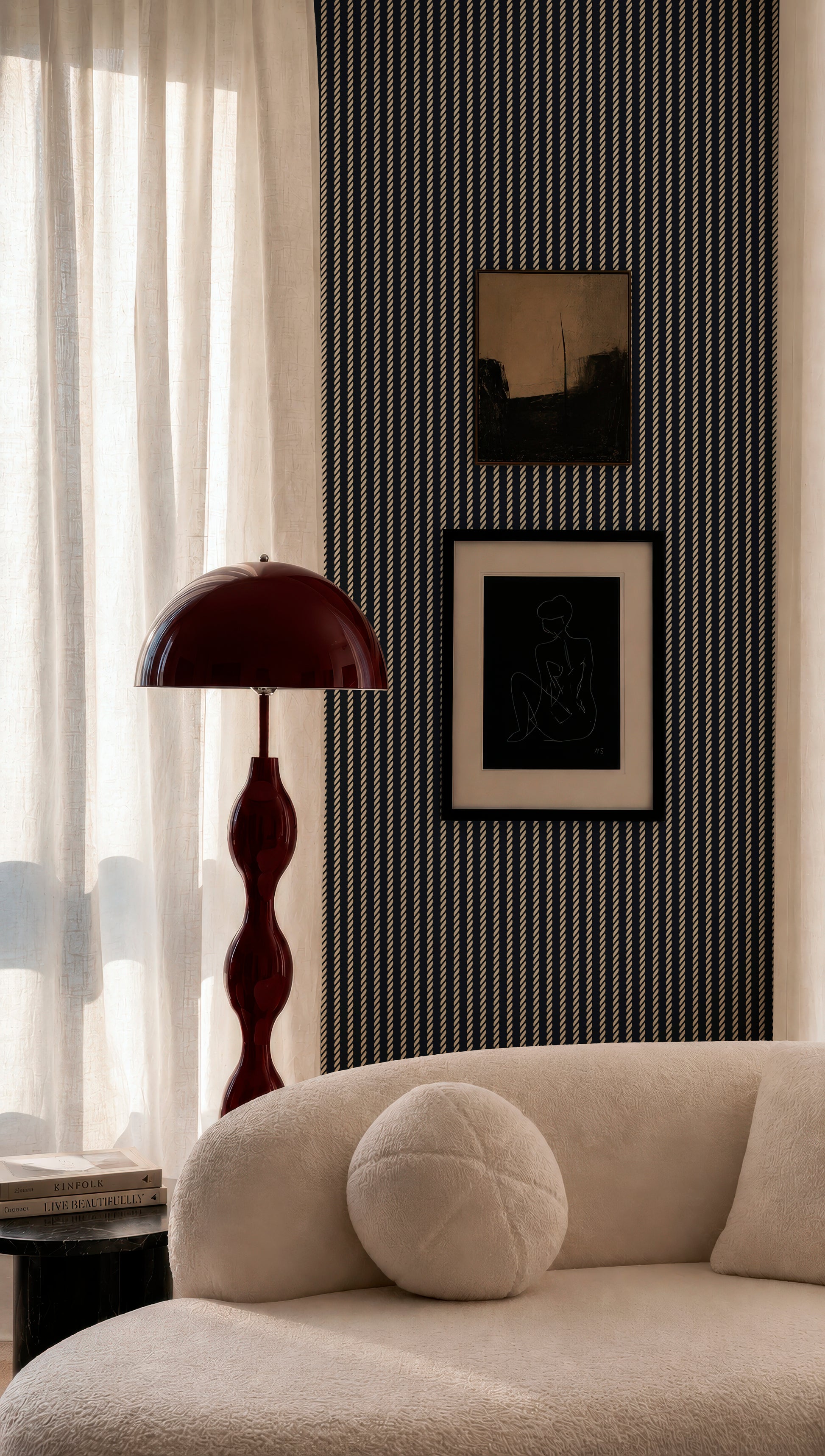 a modern living room with a white sofa, a red floor lamp, and a framed artwork on the wall.