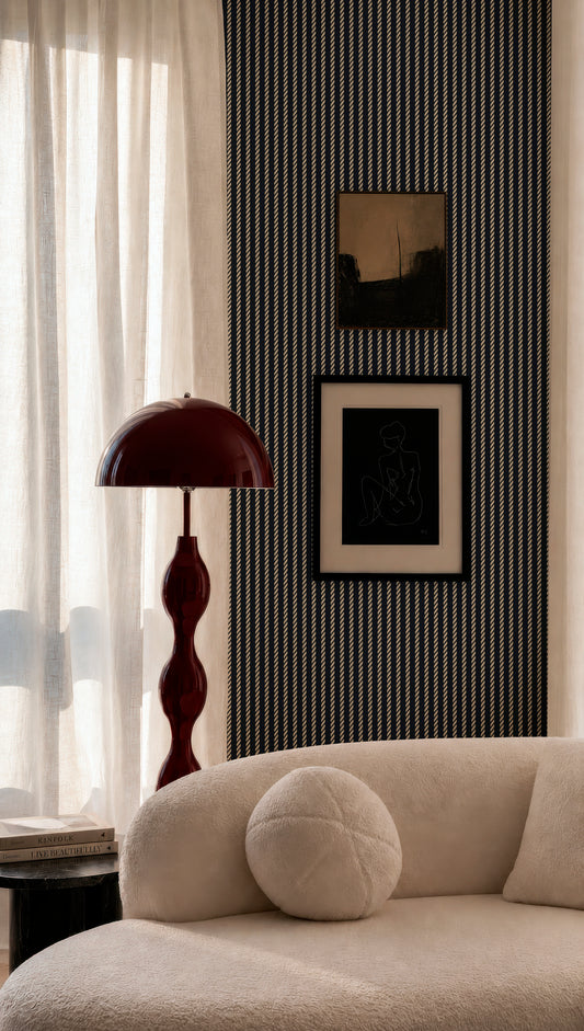 a modern living room with a white sofa, a red floor lamp, and a framed artwork on the wall.