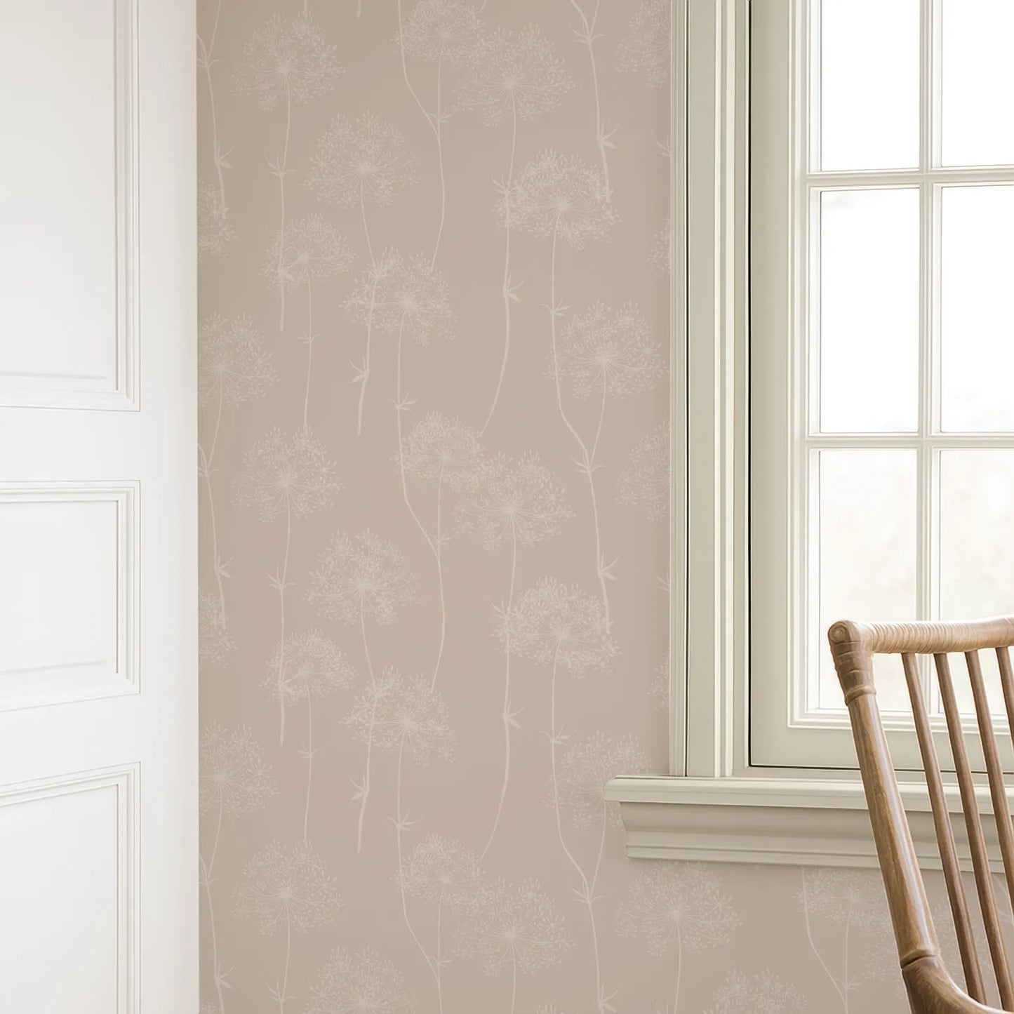 a wallpapered wall with a window and a wooden chair in the corner.