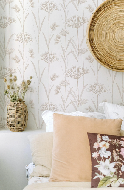 a cozy bedroom setting with a floral wallpaper, a woven basket, and a round woven basket on the wall.
