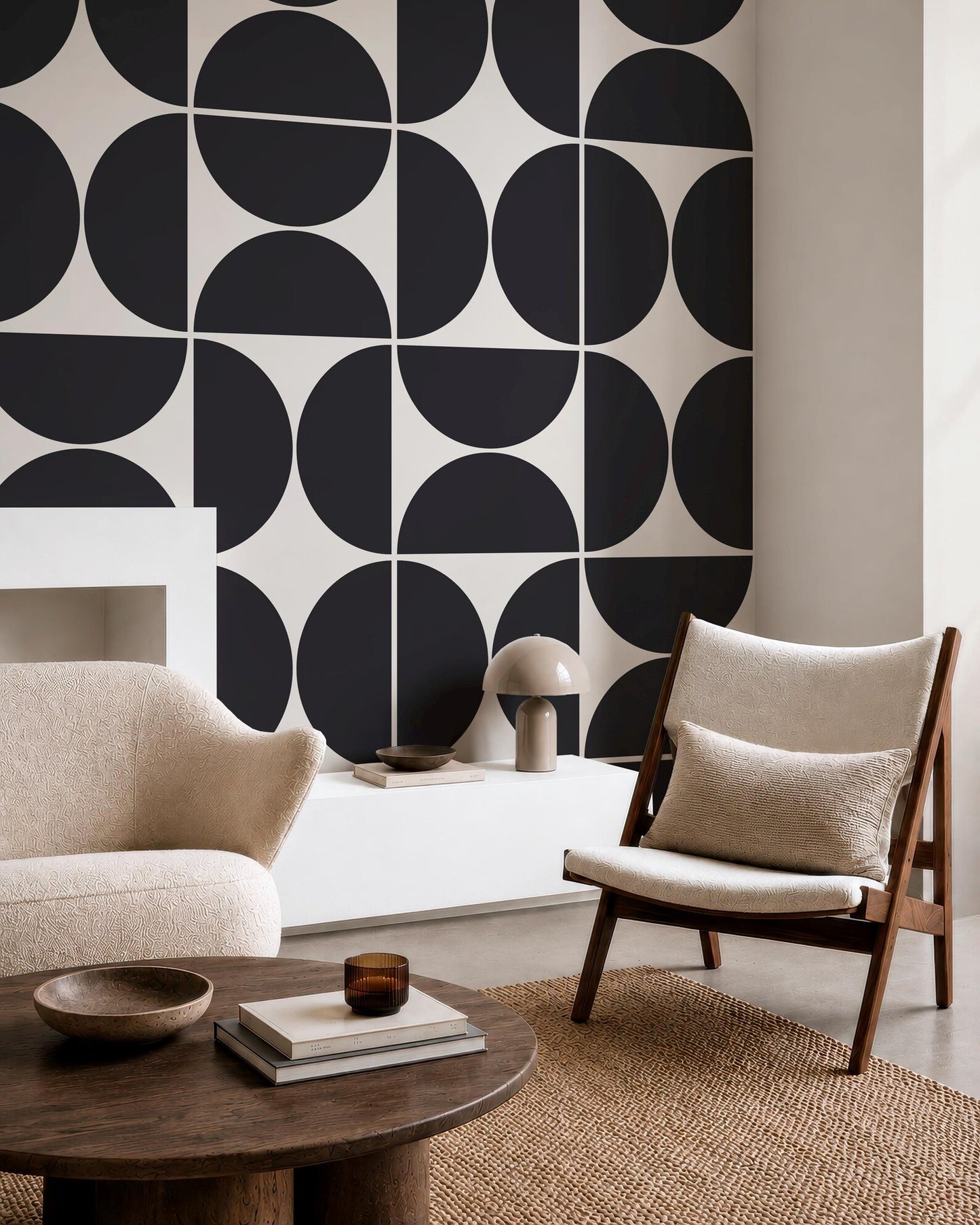 a modern living room with a black and white geometric pattern on the wall behind a wooden chair and a round wooden coffee table.