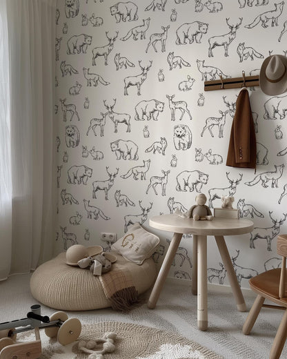 a room with a white wall decorated with a black and white animal print wallpaper. The room includes a round table, a bean bag chair, and a wooden rocking chair.